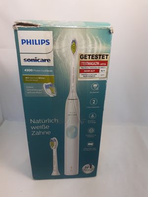 packaging of a philips soniccare electric toothbrush on a white surface