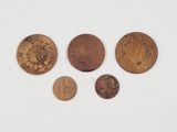a group of coins sitting on top of a white surface