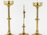 two gold candlesticks with a crown on top of them