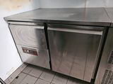 a stainless steel counter top in a kitchen with tile flooring