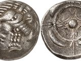 a silver coin with an image of a bird on it