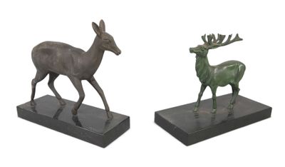 pair of bronze sculptures of a deer and a stag on a marble base