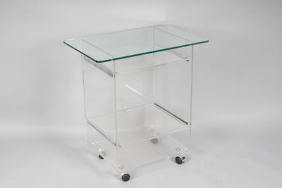 a clear glass side table with wheels on a white background