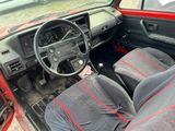a red car with two black seats and a steering wheel