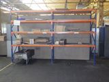 a room with shelves and a work bench in it