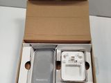 a box with a cell phone and a charger inside of it