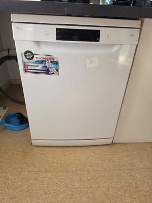 a white dishwasher sitting in a kitchen next to a counter
