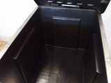a black box with a lid open on a tiled floor