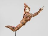 statue of a woman with a hood on her head in the air