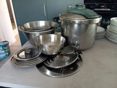 many pots and pans on the counter in the kitchen