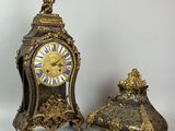 two clocks sitting next to each other on a table