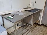 a kitchen with a sink and a refrigerator in it