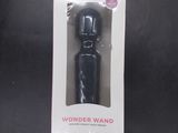 a box with a black wand in it on a table