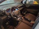 the interior of a small car with a steering wheel and dashboard