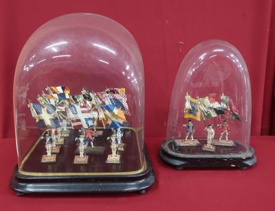 two glass cloches that have been placed on a table