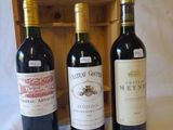 three bottles of wine sitting next to each other on a table