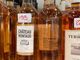 several bottles of wine are lined up on a shelf