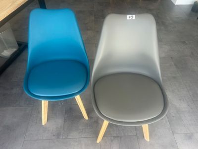 two blue and gray chairs sitting next to each other
