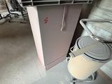 a trash can sitting next to a trash can in a room