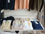 a lot of clothes on display in a clothing store