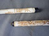 two pens that are sitting on top of a table