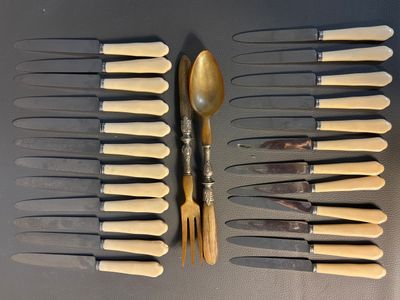 a lot of knives and spoons that are on the table