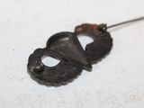 a small metal object with a hole in the middle