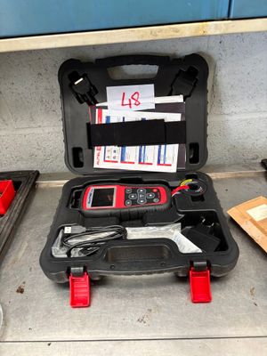 a tool case with tools in it sitting on the floor