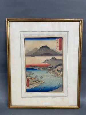a framed picture of a mountain with a river in the foreground