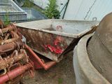 a rusty wheelbarrow and a rusty wheelbarrow in a yard