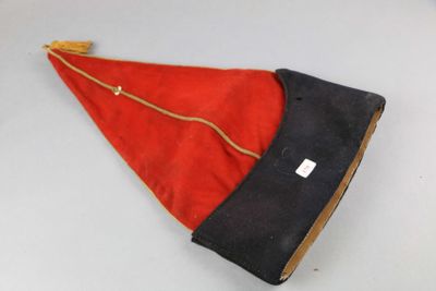 a red and black hat on a white table