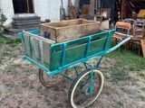 a green wagon with a wooden box in it