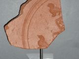 a stone object on a stand on a gray surface