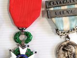 two medals and a medal on a white surface