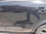 a black car that has a broken door handle on the side of it