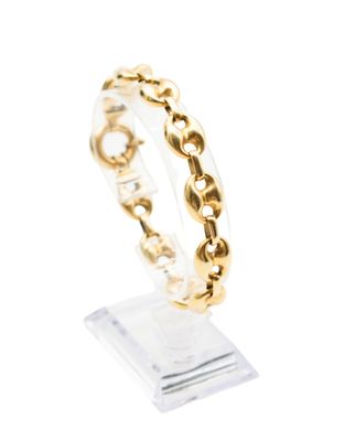 a close up of a gold ring on a clear stand