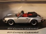 a model of a silver porsche cabriot in a display case