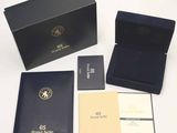 a black box with a gold logo on it next to other items
