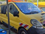 a yellow van that is parked next to a trailer