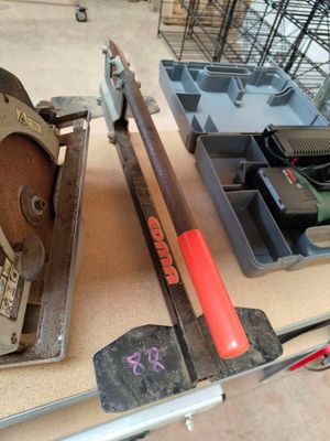 a table with tools on it that include a saw, a tool holder, and a tool tray