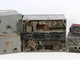 three old radio ' s that are sitting next to each other