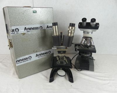 three microscopes sitting next to each other on a table