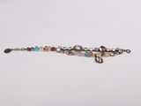 beaded bracelet with multi colored glass beads on a white surface