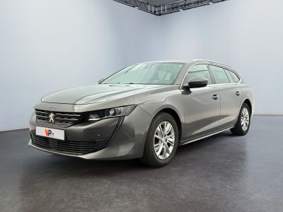 the grey car is parked in a large room with a black floor