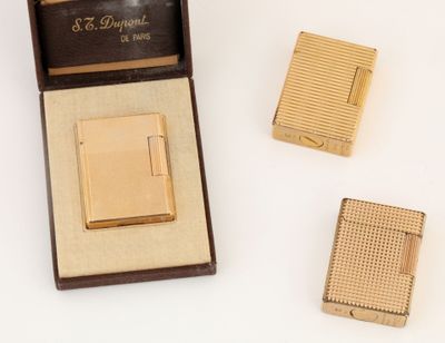 an image of a gold cigarette case and lighter in a box