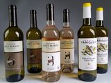 several bottles of wine are lined up on a table