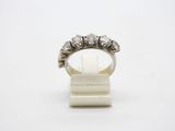 a close up of a diamond ring on a white surface