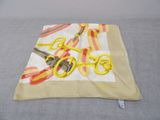 a yellow pair of scissors and a yellow pair of scissors on a cloth