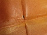a piece of brown leather that has been torn off