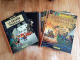 three children ' s books sitting on a wooden table next to each other